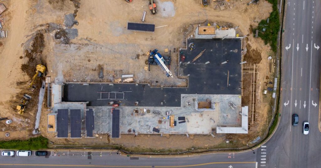 Aerial view of an active construction site with machinery and vehicles.
