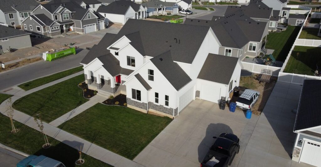 Aerial shot of a modern residential area in Spanish Fork, UT with white houses.