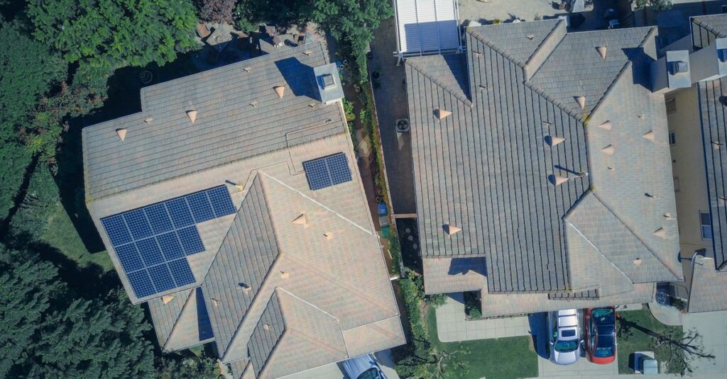 Top view of houses with solar panels, showcasing clean energy and sustainability.